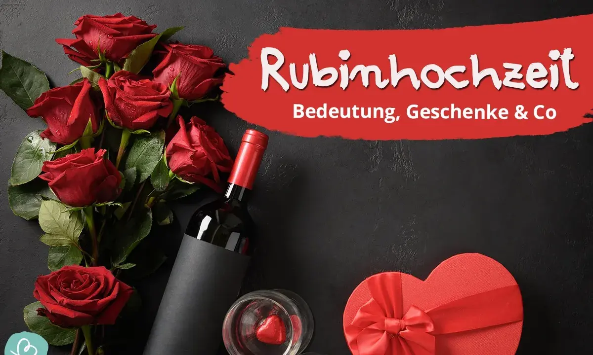 Rote Rosen, Wein und eine Herzschachtel symbolisieren die Rubinhochzeit Bedeutung. Ein Fest der Liebe nach 40 Jahren Ehe.