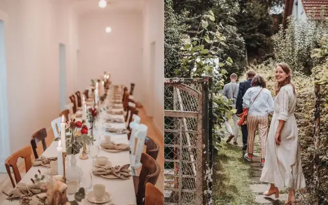 Festlich gedeckter Tisch für eine Hochzeit im kleinen Kreis. Eine Gruppe von Gästen geht durch einen Garten.