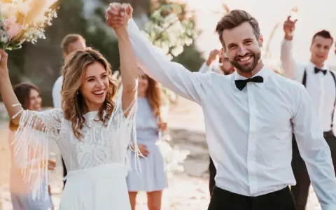 Glückliches Brautpaar feiert am Strand. Mit diesen spartipps hochzeit wird die Feier unvergesslich, ohne das Budget zu sprengen.
