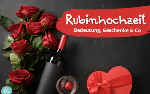 Rote Rosen, Wein und eine Herzschachtel symbolisieren die Rubinhochzeit Bedeutung. Ein Fest der Liebe nach 40 Jahren Ehe.
