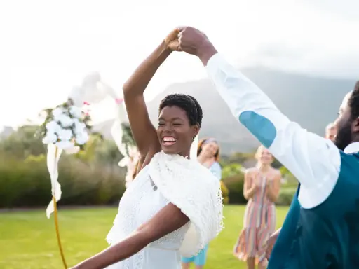 Glückliches Brautpaar tanzt im Freien. Viele Paare entscheiden sich für eine Sommerhochzeit, denn dann heiraten die meisten.